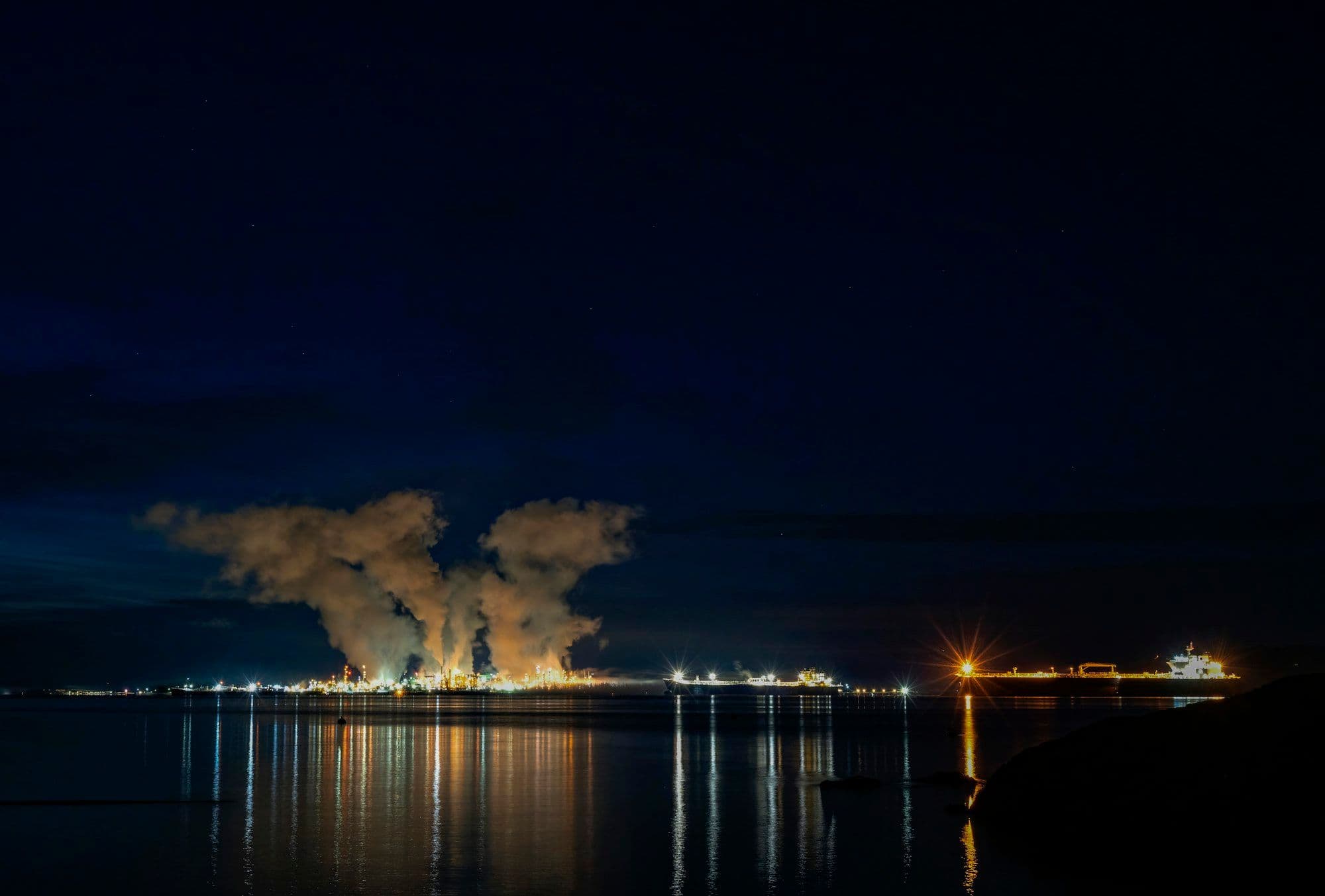 Industrial energy facility silhouetted at dusk